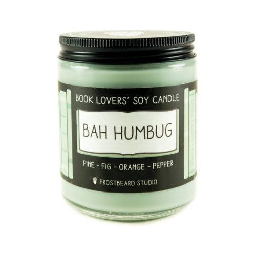 A light green candle in a glass jar with a black metal lid.