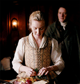 ergus coming up behind Marsali and embracing her. She smiles happily and lovingly at him.