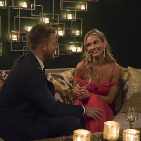 Colton and Bri sit on a drinking sofa