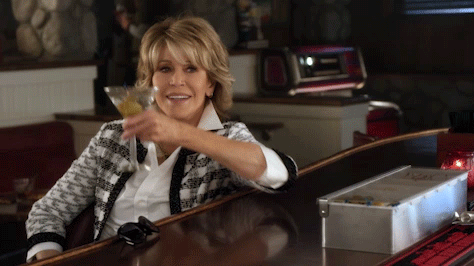 Jane Fonda toasting with a big martini