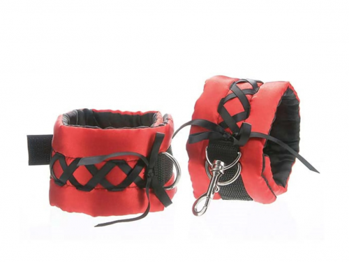 A pair of satin wrist cuffs in red and black.