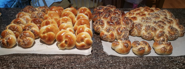 A massive array of baked challah and rolls