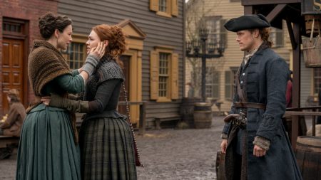 Claire hugs Bree while Jamie looks on