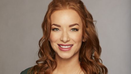 A headshot of Other Elyse. She's got light red hair, immaculate eyebrows, and a really great lipstick on.