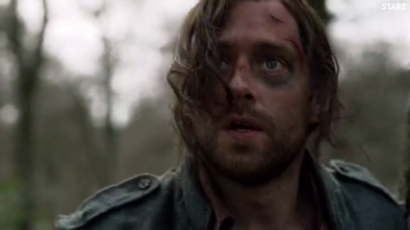 A close up of Roger's face, dirty and beat up. He has a black eye.