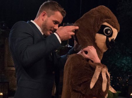 Colton helps a contestant remove the head from her sloth costume. I actually just typed those words.