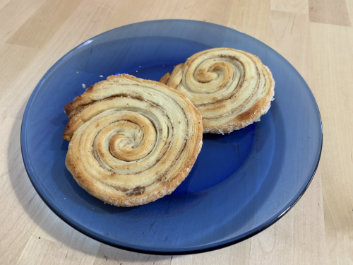 A couple of pale arlettes. They look like squished, flat cinnamon rolls.