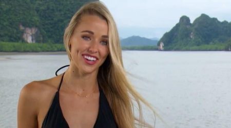 A shot of Heather smiling with the ocean behind her