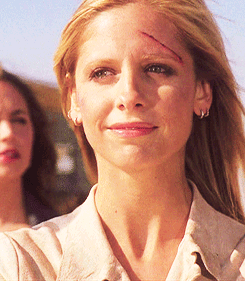 Buffy looking beat up but smiling