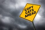 Road sign that reads Copy Cats Ahead
