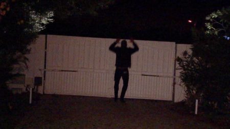 A grainy shot of Colton jumping a fence