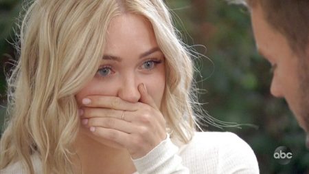 Cassie has her hand over her mouth, looking stunned