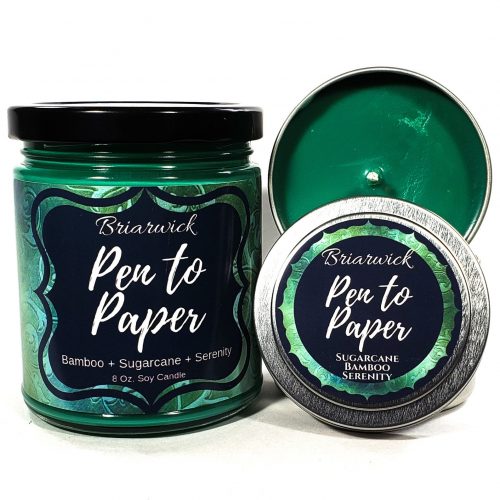 A deep green candle in a glass jar.