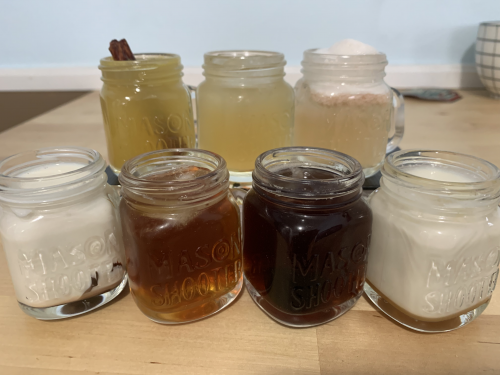A display of seven mason jar cocktails
