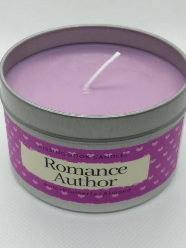 A light purple candle in a metal tin.