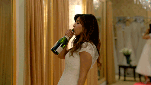 A woman drinks straight from a wine bottle