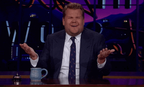 James Corden shrugs and holds up his hands