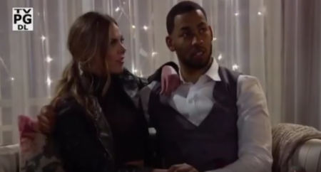 Hannah and Mike sit on a couch looking up at Cam like WTF is wrong with you