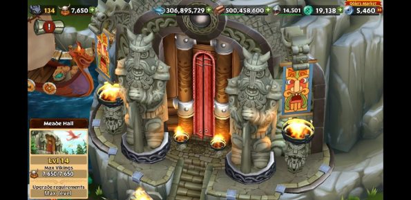 Screenshot of Meade Hall, the giant hall built into a mountain with two large rock statues of vikings outside and tons of banners and fire torches around it.