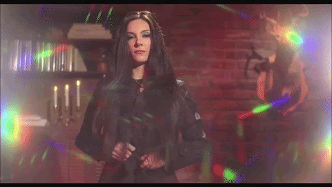 a woman undressing and showing off her coat with a rainbow lining