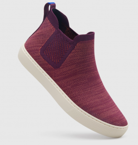 An ankle bootie sneaker in a variegated plum red with elastic at the ankle and a loop to pull on and off, with a thick white sole They're so freaking cute.