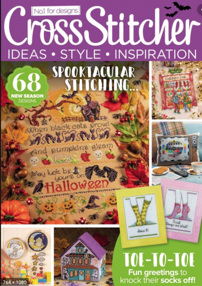 Cross Stitcher magazine cover with a halloween sampler that hasbats and ravens and pumpkins on a dark tan aida fabric