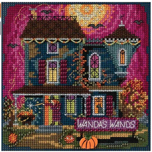 Wanda's Wands, a big blue Victorian house with a red orange sunset that's a wand selling shop