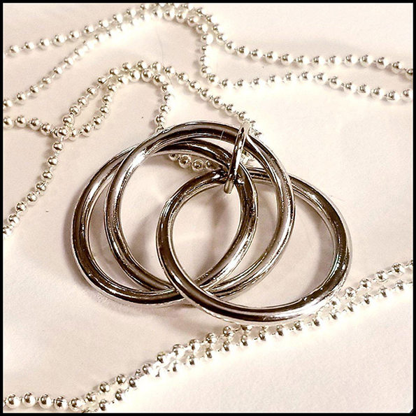 A silver ball necklace with a pendant of three interlocking silver rings