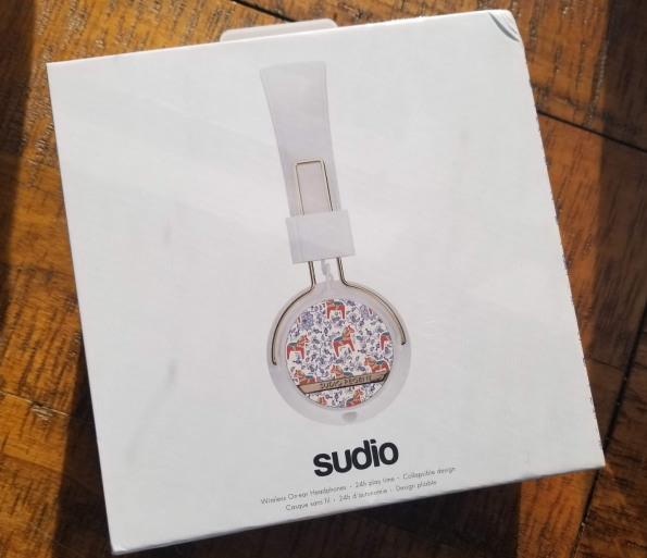 Sealed box of Sudio Regent II headphones on a wood table top