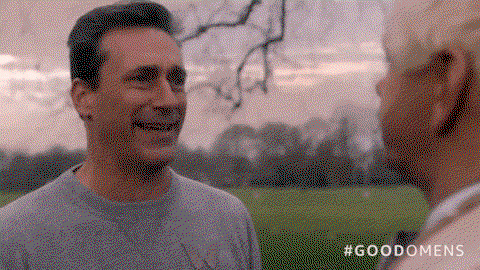 John Hamm smiling insincerely and squinting his eyes at Sheen
