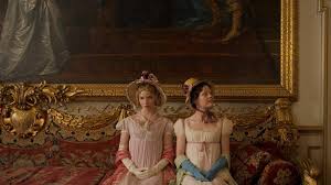 Emma and Harriet on a couch in front of an enormous painiting