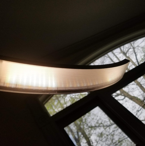 underside of the lamp with gold and white LED bulbs sort of visible 