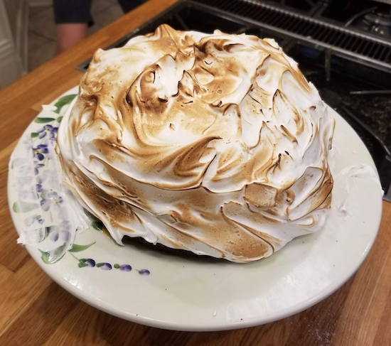 Toasted meringue in a dome on a cake stand 