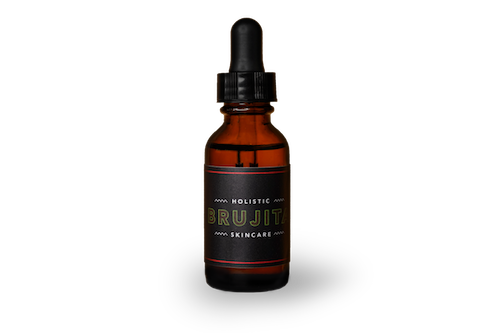 Hechizo Facial Serum in a dark glass bottle with a dropper stop cap 