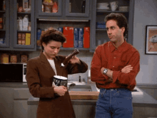 Julia Louis-Dreyfus on Seinfeld pouring chocolate sauce from the bottle into a gallon of ice cream looking very sad