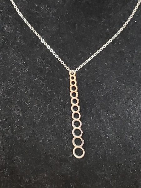 A necklace made up of rings that can be used to size needles