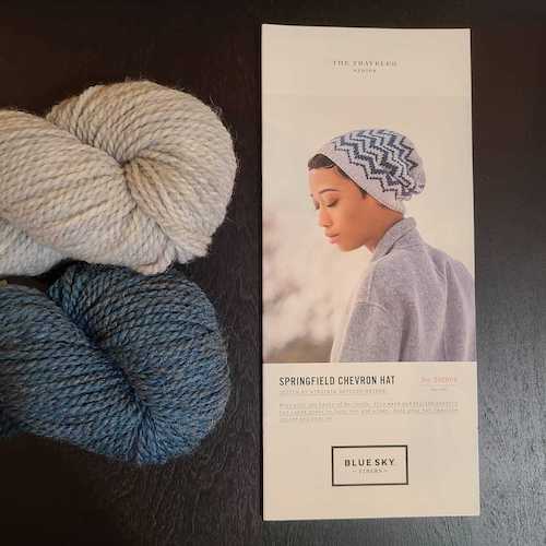 Blue Sky Springfield chevron hat pattern with cream and slate blue yarn