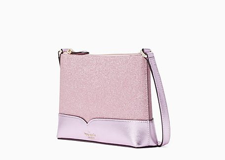 Side view of cross body bag with pink glitter sides and a glossy pink bottom panel 