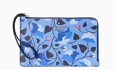 A blue wristlet purse with a zipper on the top and side with a pretty blue floral illustration print