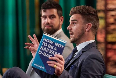 Noah holds a book that says how to not be a harvard dbag