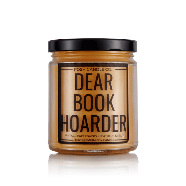 posh candle dear book hoarder a dark orange candle in a metal lid jar