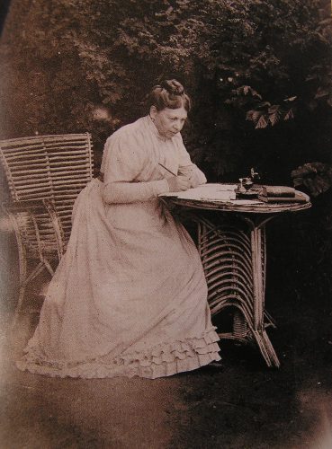 photo of Tolstaya writing at a small table