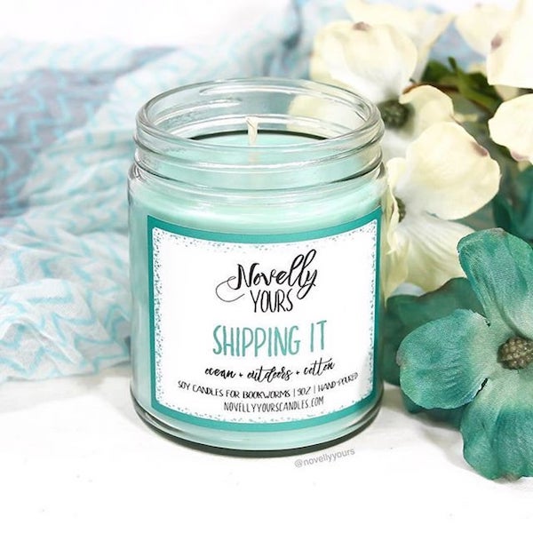 Novelly Yours shipping it a teal green candle with flowers behind it