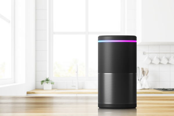 Voice controlled smart speaker standing on kitchen table. Concept of technology and electronics. 3d rendering