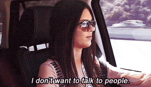 a woman with long hair and sunglasses behind the wheel of a car says I don't want to talk to people