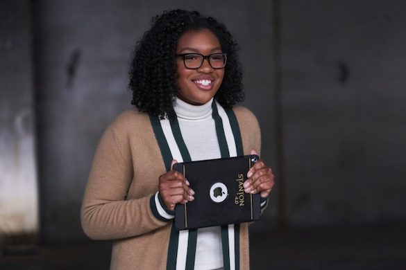 Taylor Mosby as Spencer's teenage daughter holding a tablet wearing a super cute striped cardigan sweater 