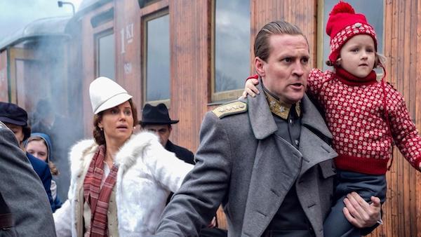 Martha and Olaf running with their children alongside a train clearly distressed