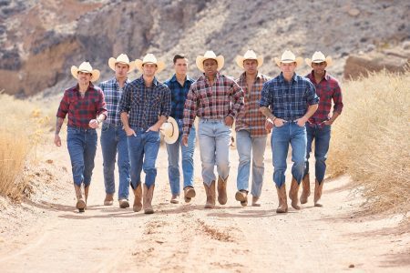 The dudes are dressed as cowboys