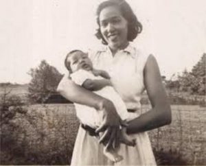 A black and white photo of young Berdis holding James Baldwin's infant brother, David