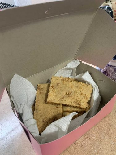 A pink cardboard box with shortbread inside